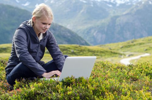 woman working on her laptop outside