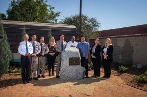 (From left) CHP Capt. Ed Krusey; Curtis Woods, general manager of Eternal Valley Memorial Park and Mortuary; and Chris Angelo, CEO of Stay Green Inc., pose for a photo at a memorial for four CHP officers killed in the 1970 shootout known as the Newhall Incident. The memorial is located outside the CHP’s Newhall Area Station and was completed through a partnership between Stay Green and Eternal Valley.